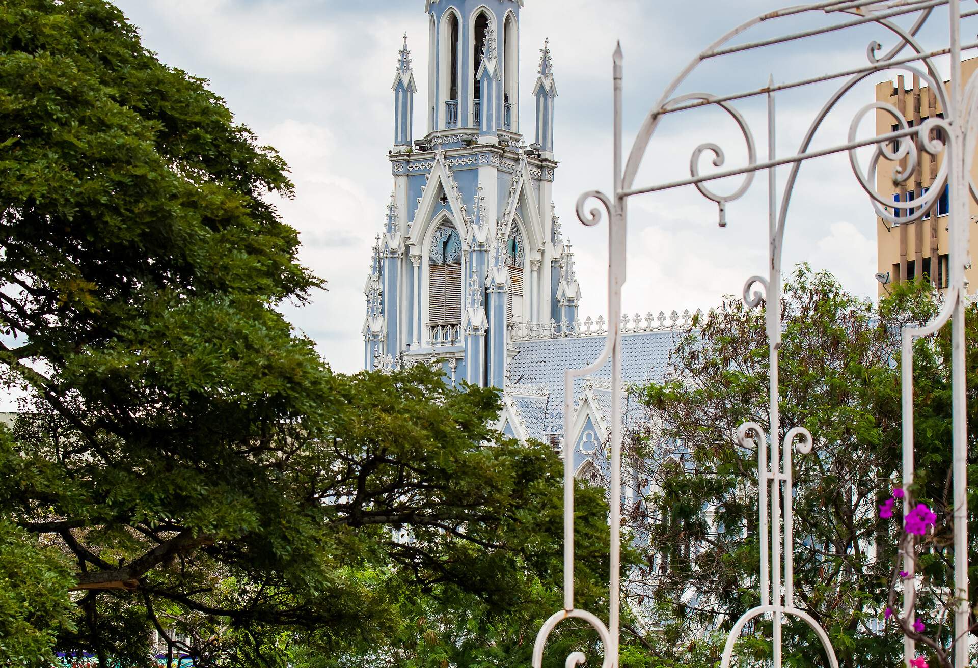 The historical gothic church of La Ermita seen from the antique Ortiz Bridge in the city of Cali in Colombia