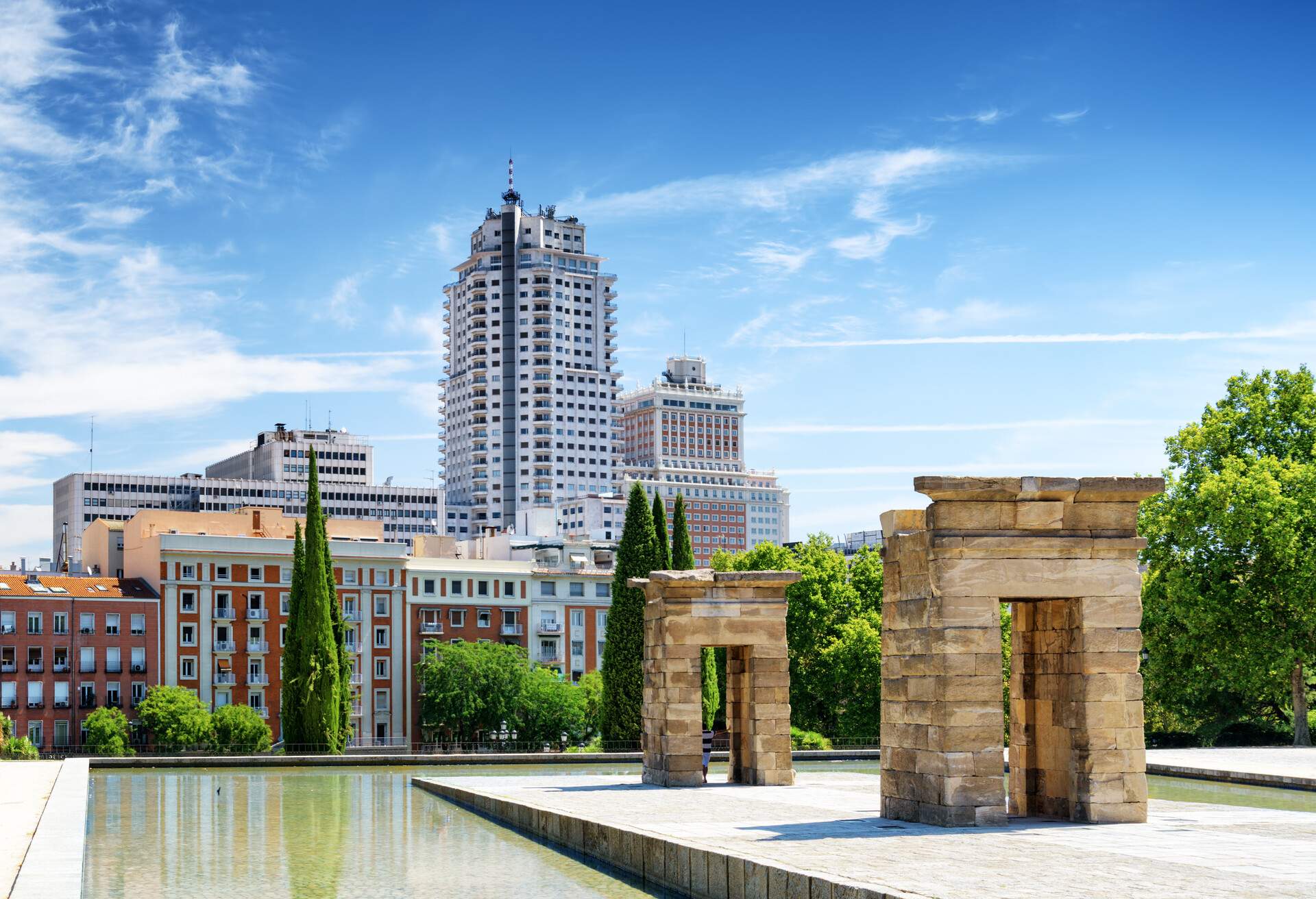 Gates to the Temple of Debod, ancient Egyptian temple, in the Parque del Oeste (Western Park) in Spain. Buildings of Madrid in the background. Madrid is a popular tourist destination of Europe.; Shutterstock ID 273100988
